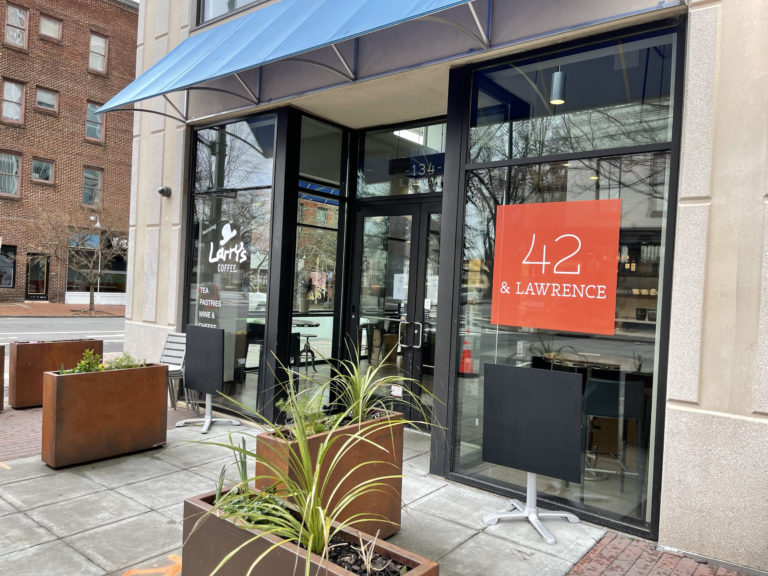 Rebranding and graphic design for downtown Raleigh coffee shop with updated logo and business name on vinyl window stickers